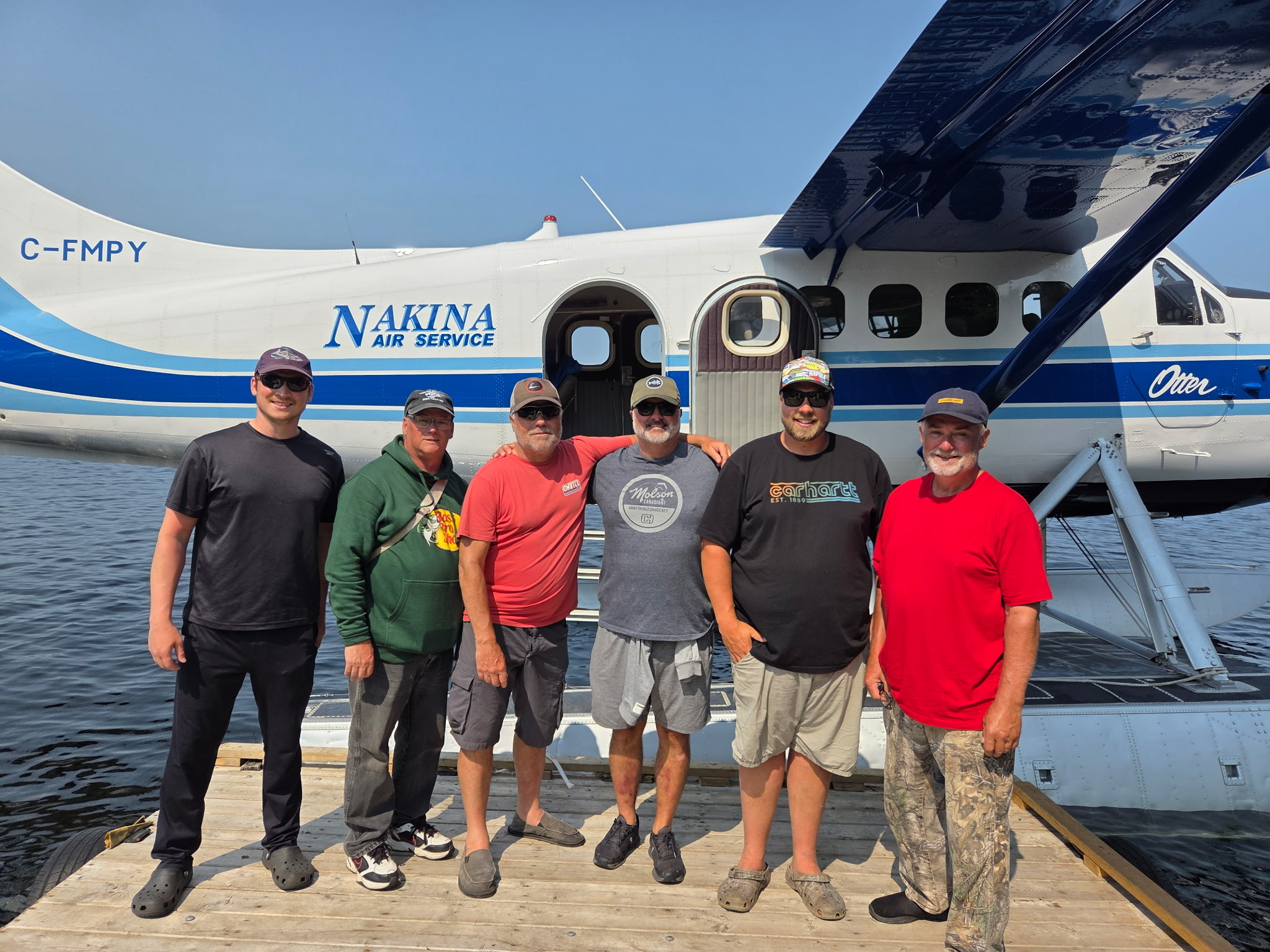 Gray Wood Outfitters guests beside a Nakina Air floatplane