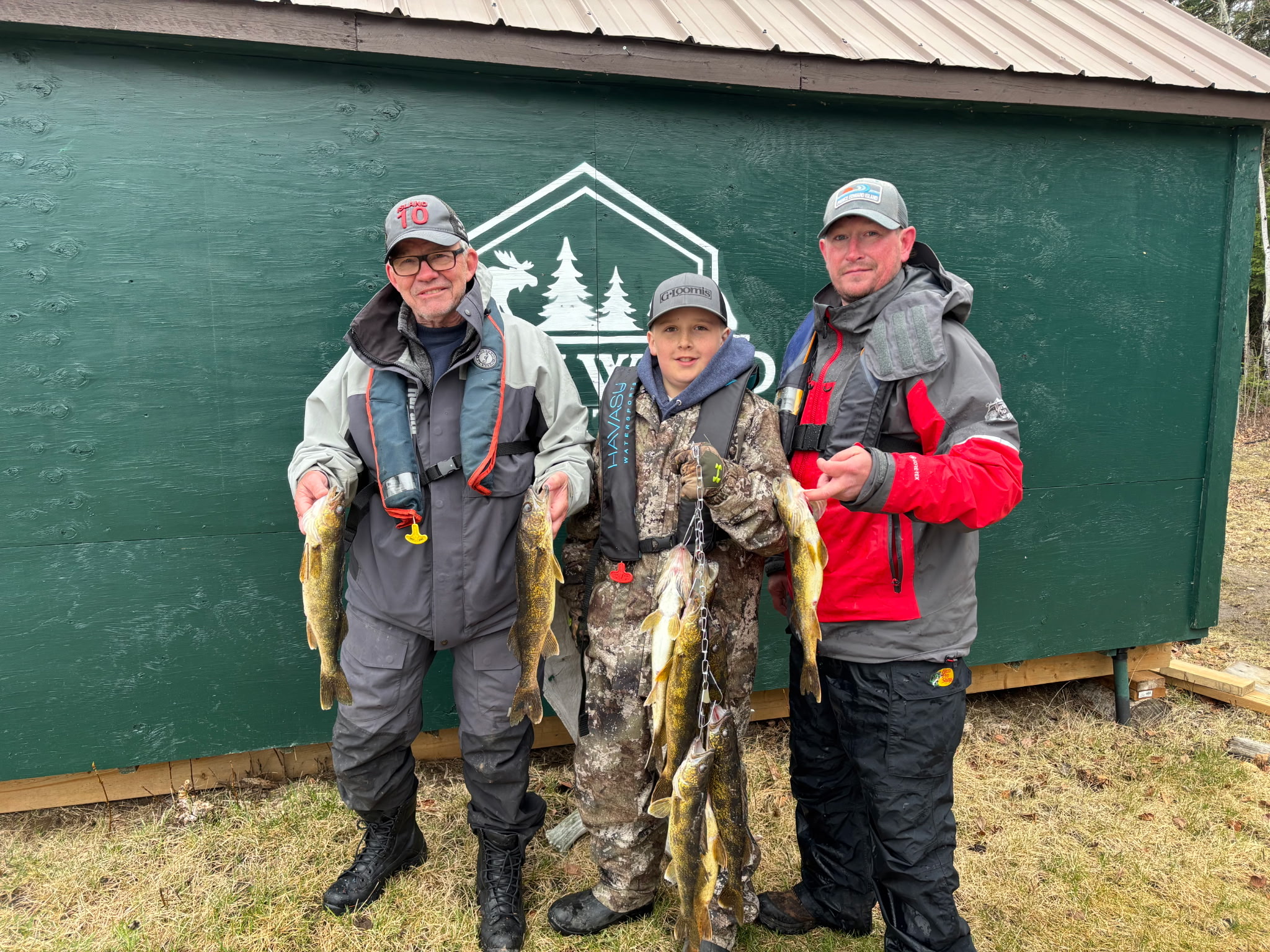 Gray Wood Outfitters fishing guests outside a remote camp cabin