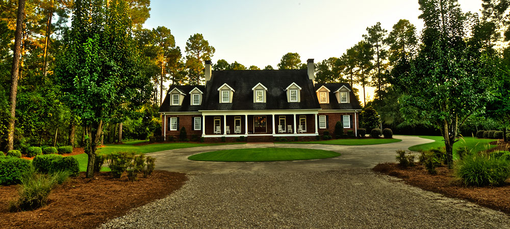 Pine Hill Plantation lodge exterior framed by Georgia pines
